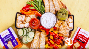 Snack platter featuring Absolutely! Gluten Free flatbreads and crackers with fresh vegetables and dips