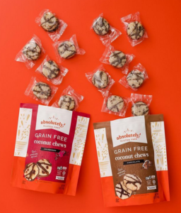 Absolutely Gluten Free coconut chews pouches with individually wrapped chews on orange.