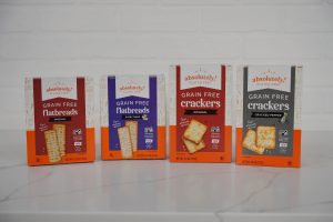 Four boxes of Absolutely! Gluten Free snacks: two flatbreads and two cracker varieties.